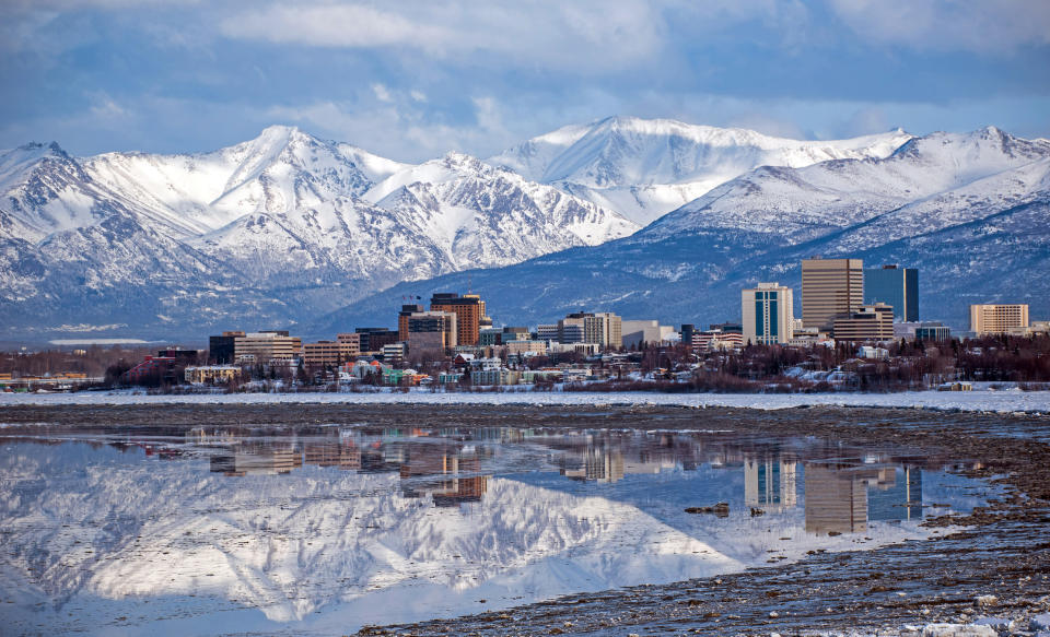 A view of Anchorage, Alaska, with snowcapped mountains in the background.