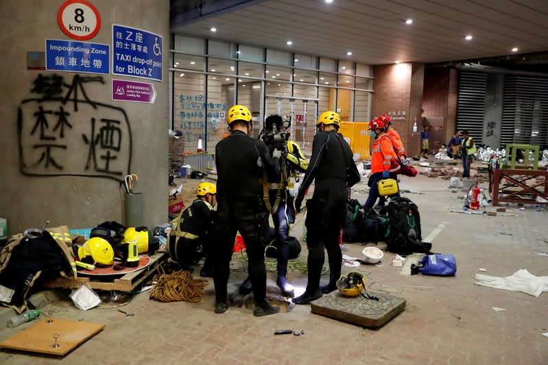 FILE PHOTO: A firefighter prepares to get into a sewage tunnel inside the Hong Kong Polytechnic University campus, in Hong Kong