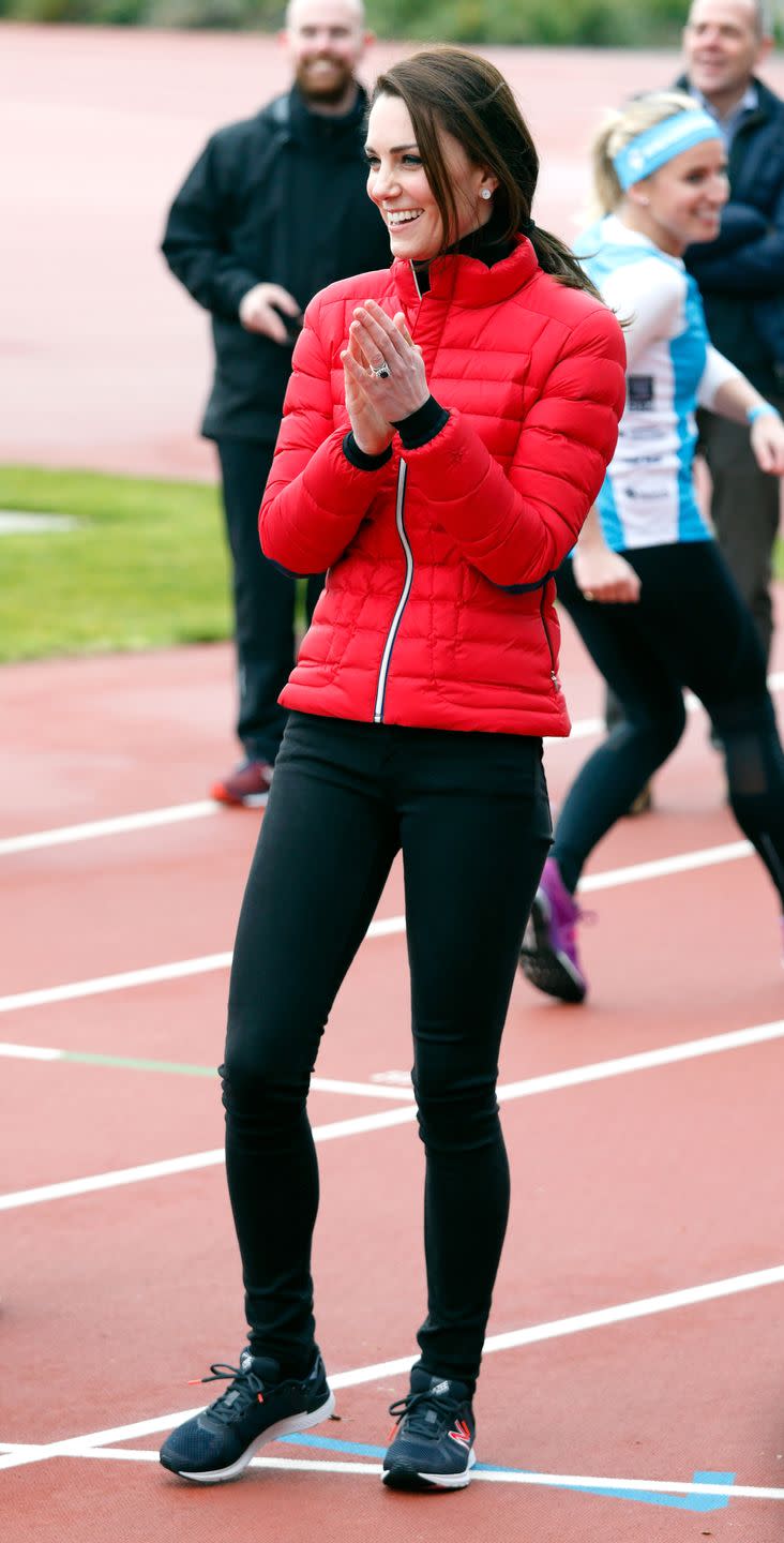 <p>Kate Middleton wears a bright red puffer jacket, black athletic leggings and New Balance sneakers at a Team Heads Together marathon with Prince William and Prince Harry in London. </p>