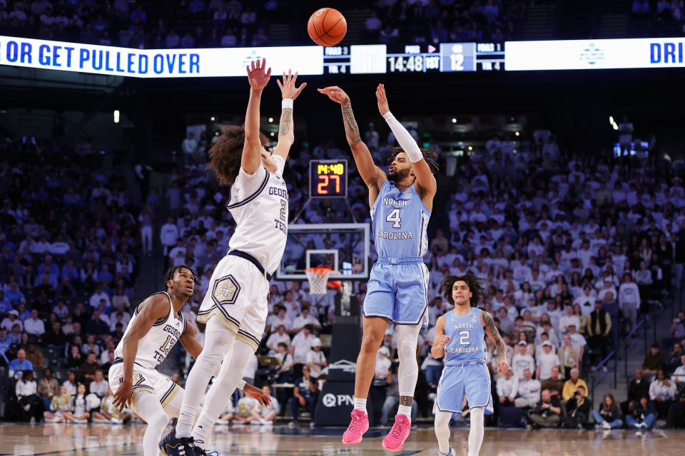 North Carolina guard RJ Davis (4) shoots a three-point basket over Georgia Tech guard Naithan George, second from left, during the first half of an NCAA college basketball game Tuesday, Jan. 30, 2024, in Atlanta. (AP Photo/Alex Slitz)