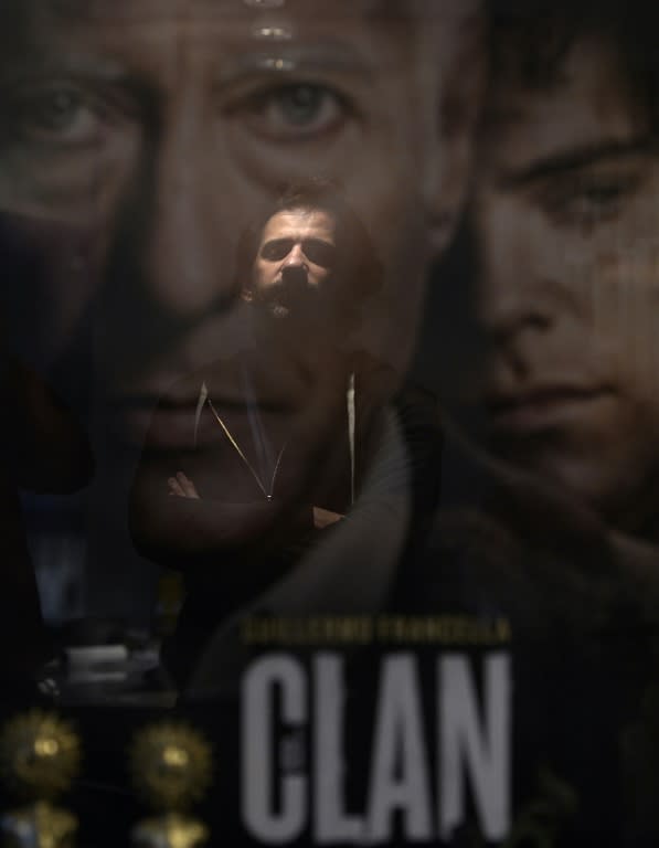 Argentine director Pablo Trapero is reflected on a poster of 'El Clan', a movie based on a true story of a middle class family dedicated to kidnapping