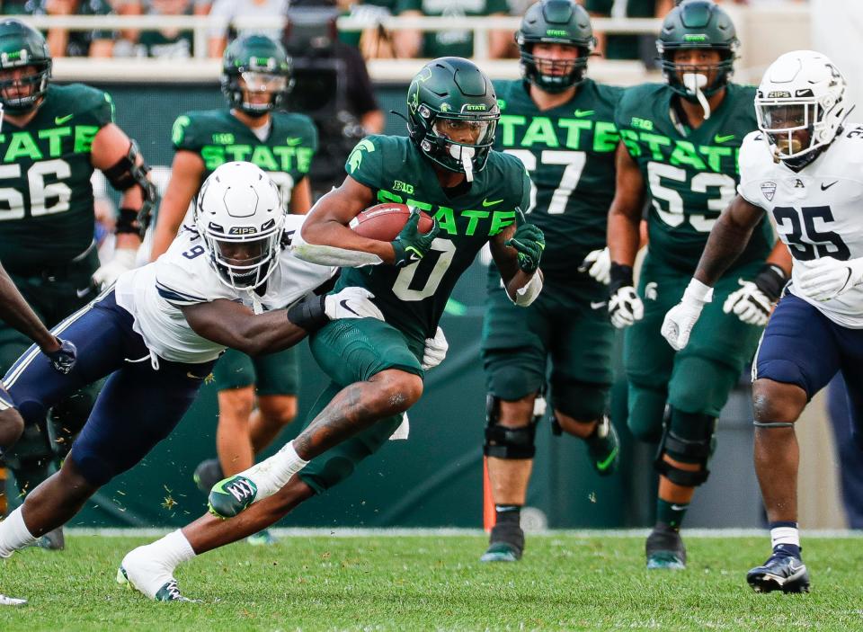 Michigan State wide receiver Keon Coleman runs against Akron linebacker Jeslord Boateng (9) during the first half at Spartan Stadium in East Lansing on Saturday, Sept. 10, 2022.