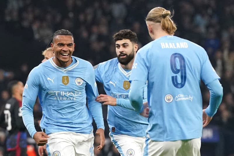 Manchester City's Manuel Akanji (L) celebrates scoring his side's first goal with teammates during the UEFA Champions League round of 16 second leg soccer match between Manchester City and FC Copenhagen at the Etihad Stadium. Nick Potts/PA Wire/dpa