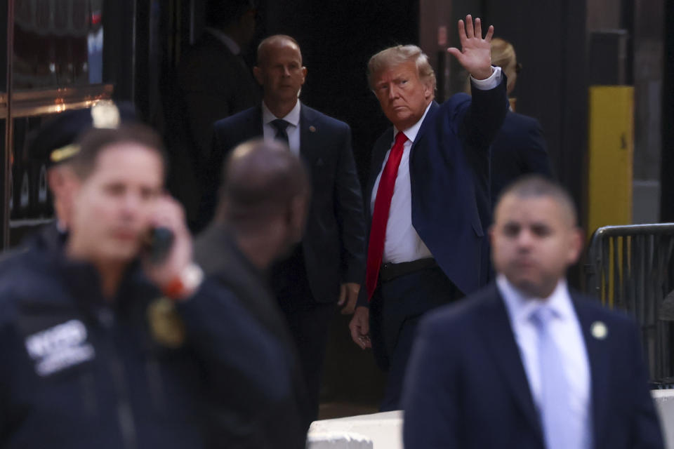 Former President Donald Trump waves to supporters upon arriving at Trump Tower, Monday, April 3, 2023, in New York. Trump arrived in New York on Monday for his expected booking and arraignment the following day on charges arising from hush money payments during his 2016 campaign. (AP Photo/Yuki Iwamura)