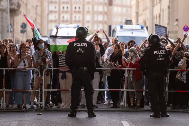 Pro-Palestinian demonstrators stand on a street near the Institute of Social Sciences at Berlin's Humboldt University (HU). Activists have occupied the university in support of the Palestinians and in protest against Israel. Christophe Gateau/dpa