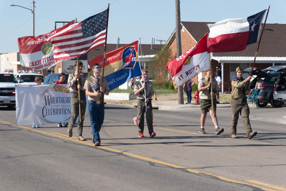 Members of Boy Scout Troop 256 and 258 carry the colors down Main Street the 104th annual Wheatheart of the Nation Parade Saturday in Perryton.