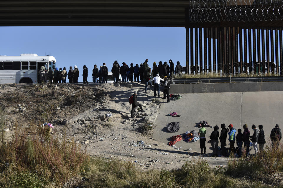 Migrants wait to get into a U.S. government bus after crossing the border from Ciudad Juarez, Mexico, to El Paso, Monday, Dec. 12, 2022. According to the Ciudad Juarez Human Rights Office, hundreds of mostly Central American migrants arrived in buses and crossed the border to seek asylum in the US, after spending the night in shelters. (AP Photo/Christian Chavez)