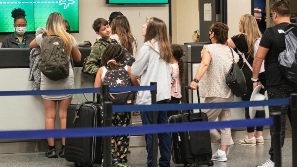 Lines form at ticket counters Friday morning, July 1, 2022 at the Charlotte Douglass International Airport.