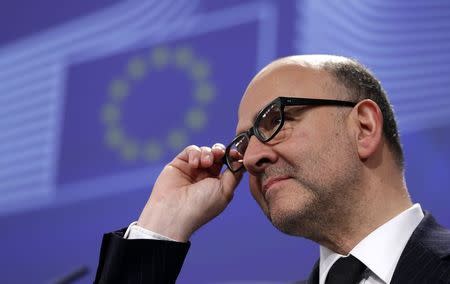 European Economic and Financial Affairs Commissioner Pierre Moscovici adjusts his glasses as he addresses a news conference at the EU Commission headquarters in Brussels February 25, 2015. REUTERS/Francois Lenoir