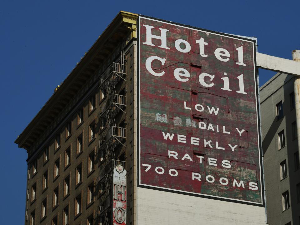 The top side of the hotel with a large red sign reading "Hotel Cecil: Low Daily Weekly Rates 700 rooms"