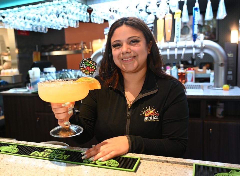 Alexandra Belteton, general manager of Sol de Mexico Bar & Grill in Milford, holds an ultimate margarita, May 3, 2022.  