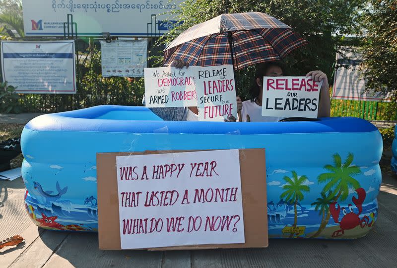 People protest against the military coup and to demand the release of elected leader Aung San Suu Kyi, outside the Japanese Embassy in Yangon