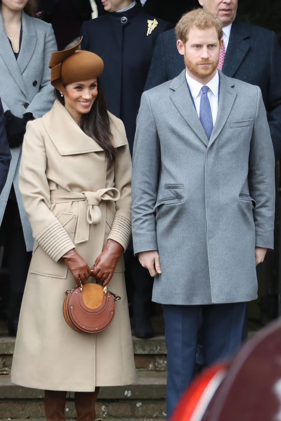 <p>For her first Royal Christmas, the soon-to-be Duchess of Sussex picked a camel tone wide collar wrap coat by Sentaler for her warm neutral holiday look.</p>
