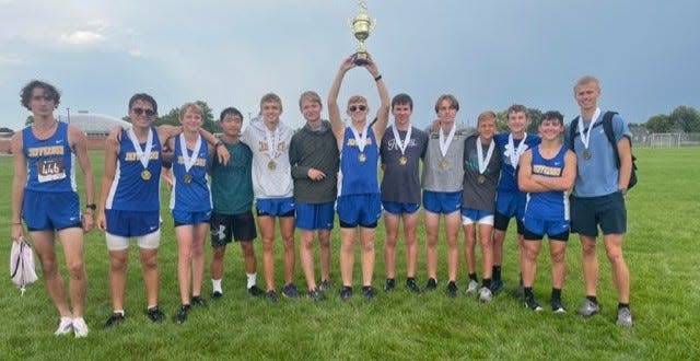 Jefferson's boys cross country team celebrates after winning the Milan Puddle Jumpers Invitational Tuesday.