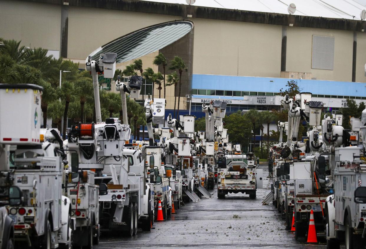 Duke Energy trucks are staged in the parking lot at Tropicana Field in St. Petersburg, Fla., in preparation for Hurricane Ian's Florida landfall on Wednesday, Sept. 28, 2022.