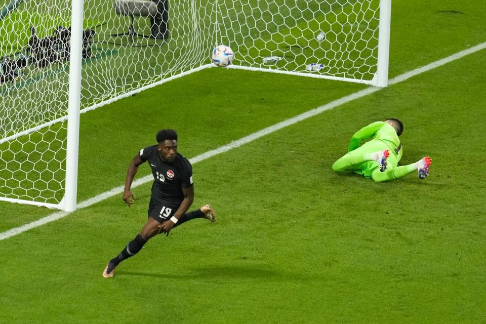 Canada's Alphonso Davies scores his side's opening goal during the World Cup group F football match between Croatia and Canada, at the Khalifa International Stadium in Doha, Qatar, Sunday, Nov. 27, 2022. (AP Photo/Themba Hadebe)