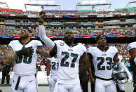 <p>Philadelphia Eagles strong safety Malcolm Jenkins, center, raises his fist as he stands between teammates Chris Long, left, and Rodney McLeod during a rendition of the national anthem before an NFL football game against the Washington Redskins, Sunday, Sept. 10, 2017, in Landover, Md. (AP Photo/Alex Brandon) </p>