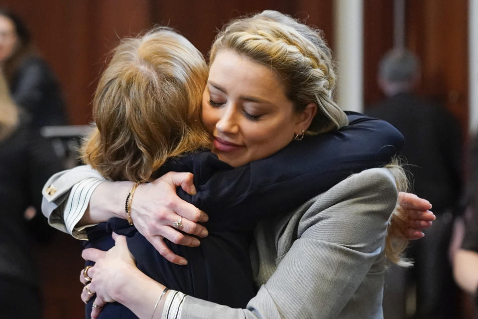 Actor Amber Heard hugs her attorney Elaine Bredehoft after closing arguments at the Fairfax County Circuit Courthouse in Fairfax, Va., Friday, May 27, 2022. Actor Johnny Depp sued his ex-wife Amber Heard for libel in Fairfax County Circuit Court after she wrote an op-ed piece in The Washington Post in 2018 referring to herself as a "public figure representing domestic abuse." (AP Photo/Steve Helber, Pool)