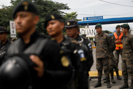 Police officers stand in line in front of the border checkpoint between Guatemala and Mexico, in Tecun Uman, Guatemala October 19, 2018. REUTERS/Edgard Garrido