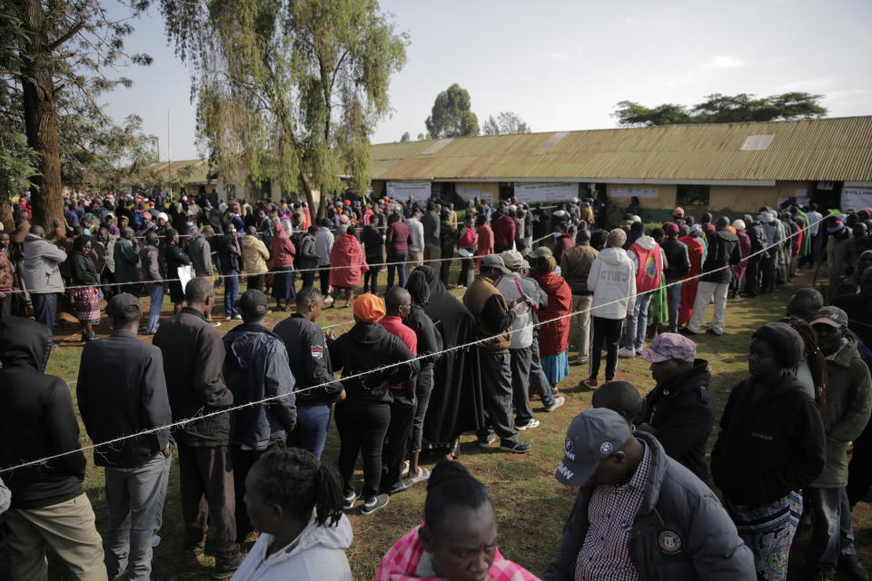 People line up to cast their vote in Kenya's general election in Sugoi, 50 kms (35 miles) north west of Eldoret, Kenya, Tuesday Aug. 9, 2022. Kenyans are voting to choose between opposition leader Raila Odinga Deputy President William Rutoto succeed President Uhuru Kenyatta after a decade in power. (AP Photo/Brian Inganga)