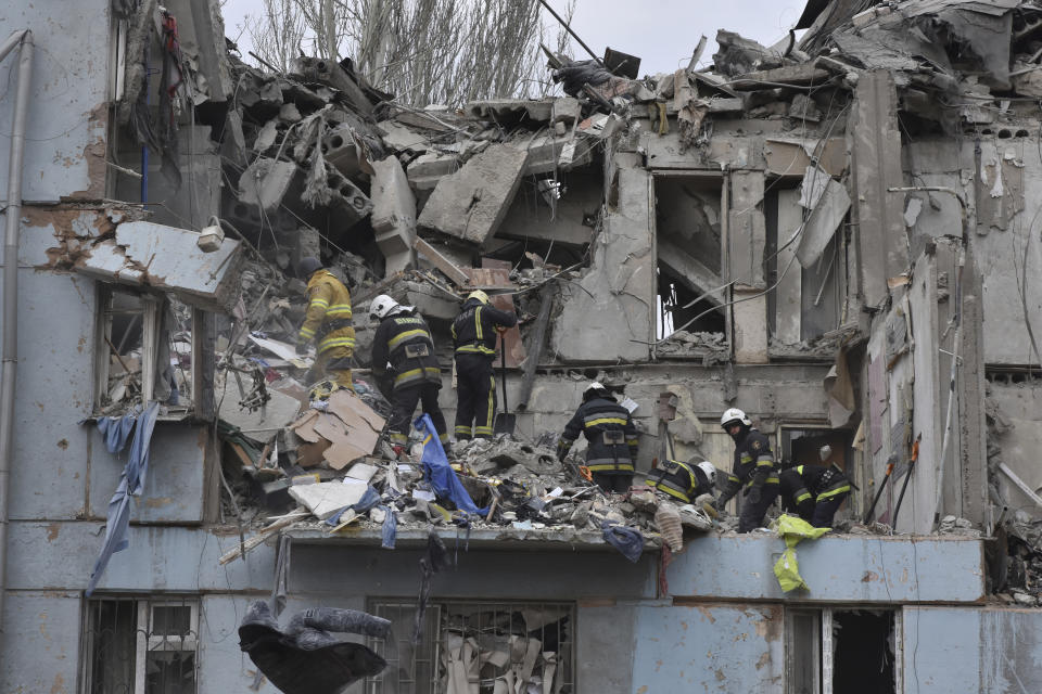 Ukrainian State Emergency Service firefighters inspect a damaged house after Russian shelling hit in Zaporizhzhia, Ukraine, Friday, March 3, 2023. (AP Photo/Andriy Andriyenko)