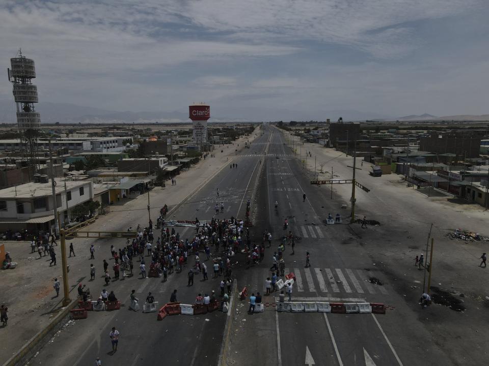 Supporters of ousted Peruvian President Pedro Castillo block the Pan-American South Highway in Ica, Peru, Tuesday, Dec. 13, 2022. Castillo said Tuesday he is being "unjustly and arbitrarily detained" and thanked his supporters for their "effort and fight" since he was taken into custody last week. (AP Photo/Martin Mejia)