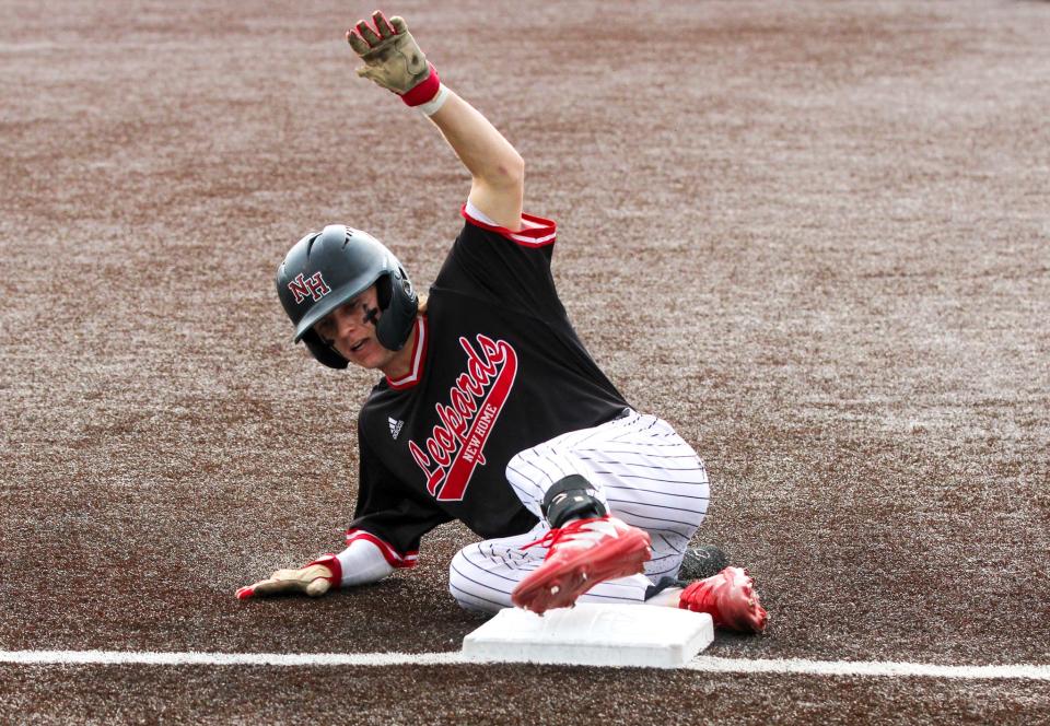 New Home's Jackson Raines slides into thrid during their Region I-2A quarterfinal baseball series at Littlefield on Thursday, May 18, 2023.
