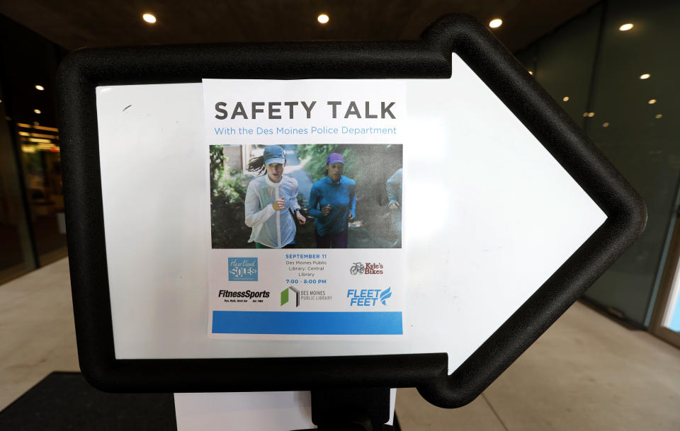 In this Tuesday, Sept. 11, 2018 photo, a sign leads female athletes to a runner's safety talk by the Des Moines Police Department, in Des Moines, Iowa. The recent killings of female athletes have raised questions about how women can defend themselves and why they must be ready to fight off attackers in the first place. (AP Photo/Charlie Neibergall)