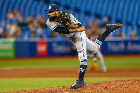 Sep 4, 2018; Toronto, Ontario, CAN; Tampa Bay Rays starting pitcher Sergio Romo (54) delivers a pitch against the Toronto Blue Jays during the ninth inning at Rogers Centre. Mandatory Credit: Kevin Sousa-USA TODAY Sports