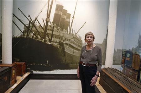 U.S. author Sonia Pressman Fuentes from Sarasota, Florida, poses next to a photo of the Belgenland, which German-born physicist Albert Einstein travelled on, while visiting the "Millions of People, One Dream" exhibition at the Red Star Line Museum in Antwerp September 24, 2013. REUTERS/Yves Herman