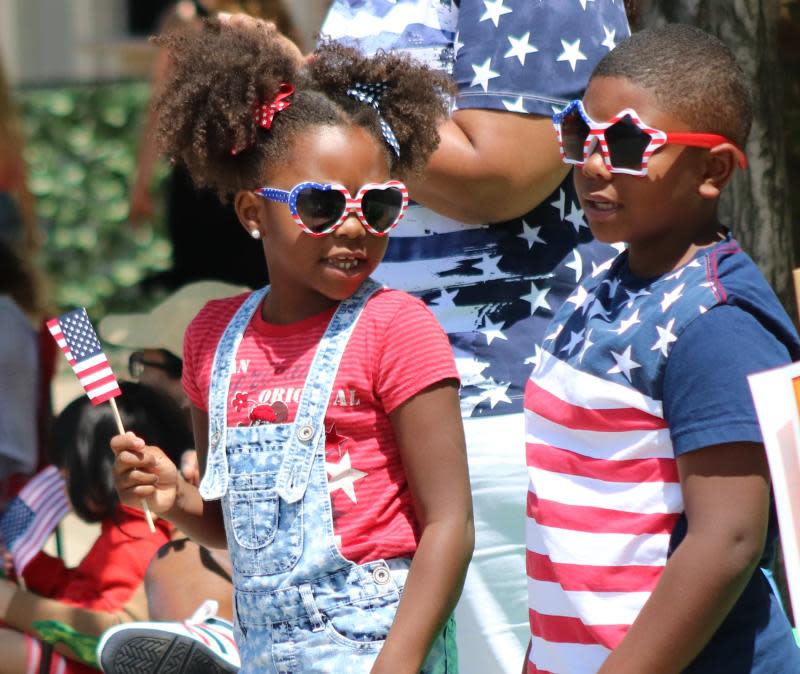 Mackenzie (left), then 6, and Grayson Rule, then 8, both of Monroe, show their patriotism during the 2019 Memorial Day Parade in Monroe.