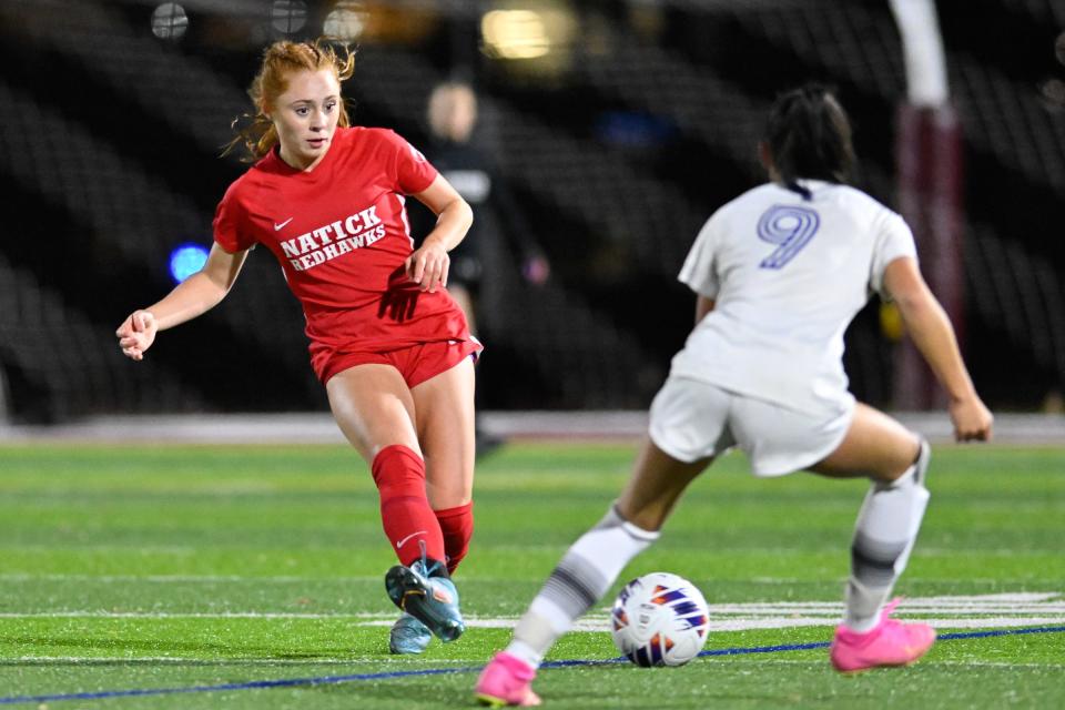 Nov 14, 2023; Boston, MA, USA; Natick junior Stella Boggis passes the ball while pressured by Brookline junior Makena Hammond during the Division 1 state semifinal soccer game at BC High. Natick defeated Brookline, 5-2. Mandatory Credit: David Sokol-The Metrowest Daily News