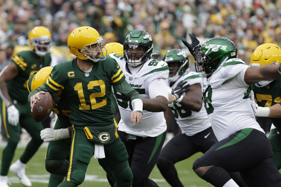 Green Bay Packers quarterback Aaron Rodgers (12) is pressured by the New York Jets defense during the first half of an NFL football game Sunday, Oct. 16, 2022, in Green Bay, Wis. (AP Photo/Mike Roemer)