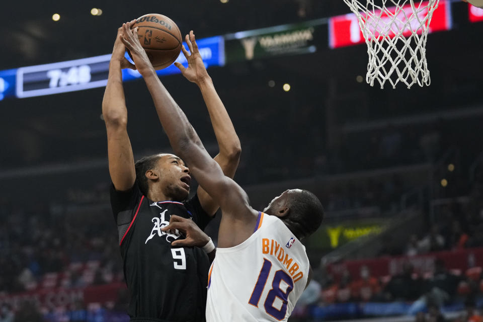 LA Clippers center Moses Brown (9) shoots against Phoenix Suns center Bismack Biyombo (18) during the first half of an NBA basketball game in Los Angeles, Thursday, Dec. 15, 2022. (AP Photo/Ashley Landis)