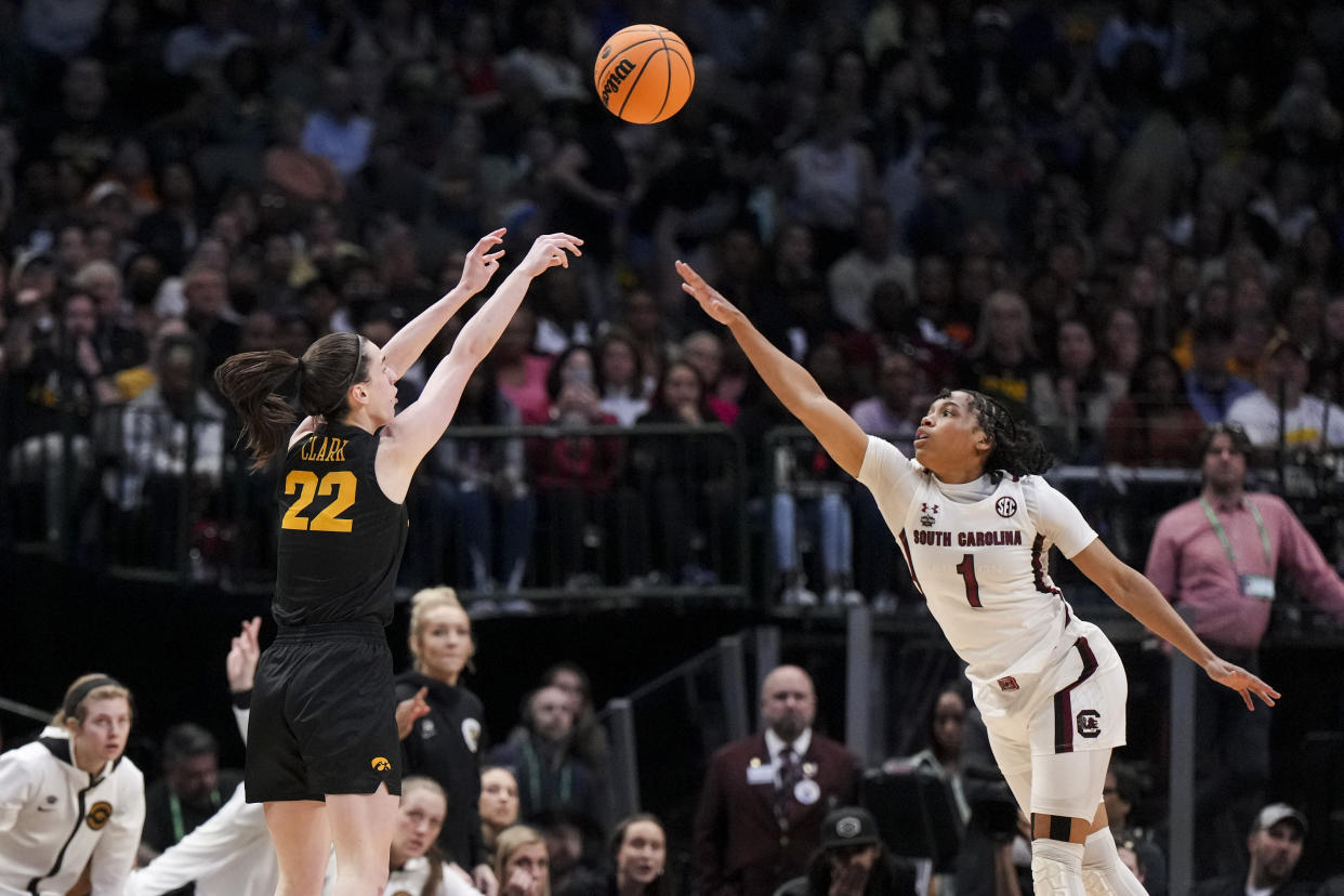 Iowa Hawkeyes guard Caitlin Clark (22) attempts a three-point basket against South Carolina Gamecocks guard Zia Cooke (1) in the second half in semifinals of the women's Final Four of the 2023 NCAA Tournament at American Airlines Center. 