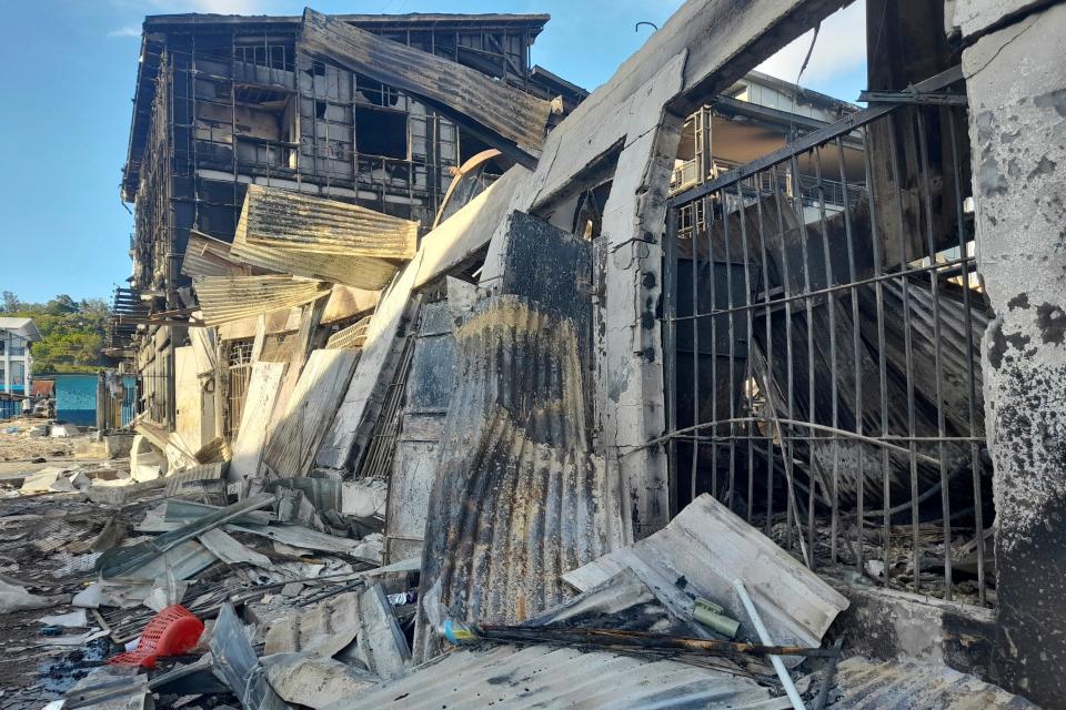 This photo shows aftermath of a looted street in Honiara's Chinatown, Solomon Islands, Saturday, Nov. 27, 2021. Violence receded Friday in the capital of the Solomon Islands, but the government showed no signs of addressing the underlying grievances that sparked two days of riots, including concerns about the country's increasing links with China.