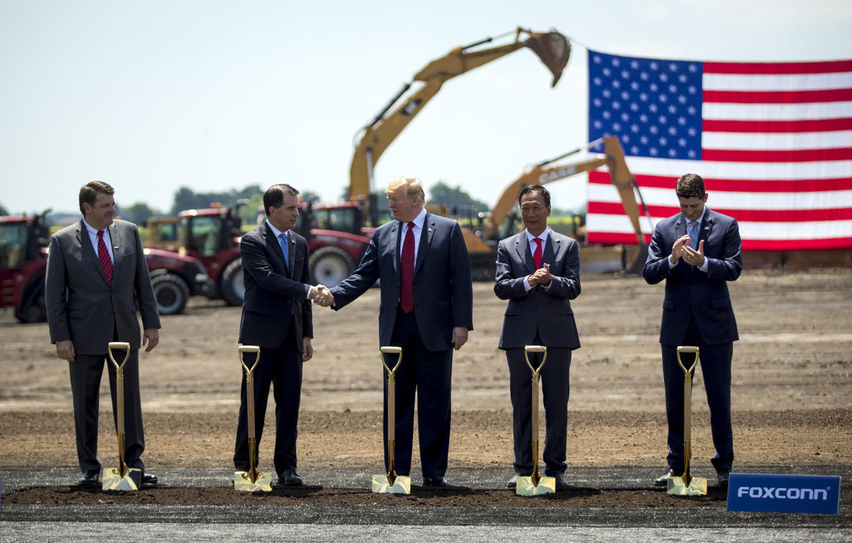 Christopher Tank Murdock, the first Wisconsin Foxconn employee, from left, former Wisconsin Gov. Scott Walker, former President Donald Trump, former Foxconn Chair Terry Gou and former House Speaker Paul Ryan at a groundbreaking for the Foxconn plant on June 28, 2018, in Mount Pleasant, Wisconsin. The company later downsized its plans and created few jobs. (Brian Cassella/Chicago Tribune/Tribune News Service via Getty Images)
