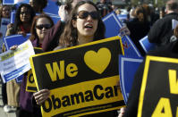 Supporters of health care reform stand in front of the Supreme Court.