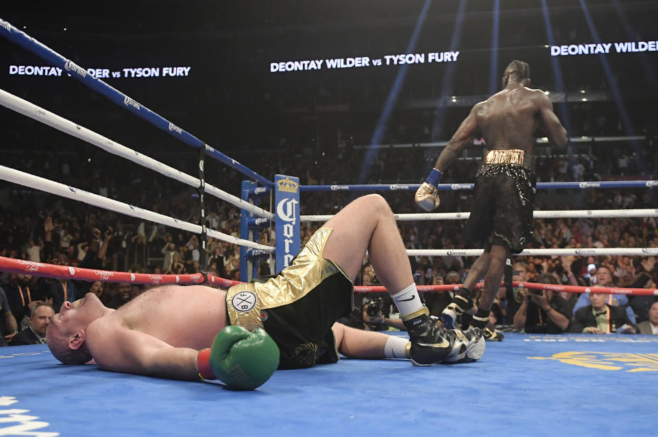 Tyson Fury, of England, lies on the canvas after being knocked down by Deontay Wilder during the 12th round of a WBC heavyweight championship boxing match Saturday, Dec. 1, 2018, in Los Angeles. (AP Photo/Mark J. Terrill)