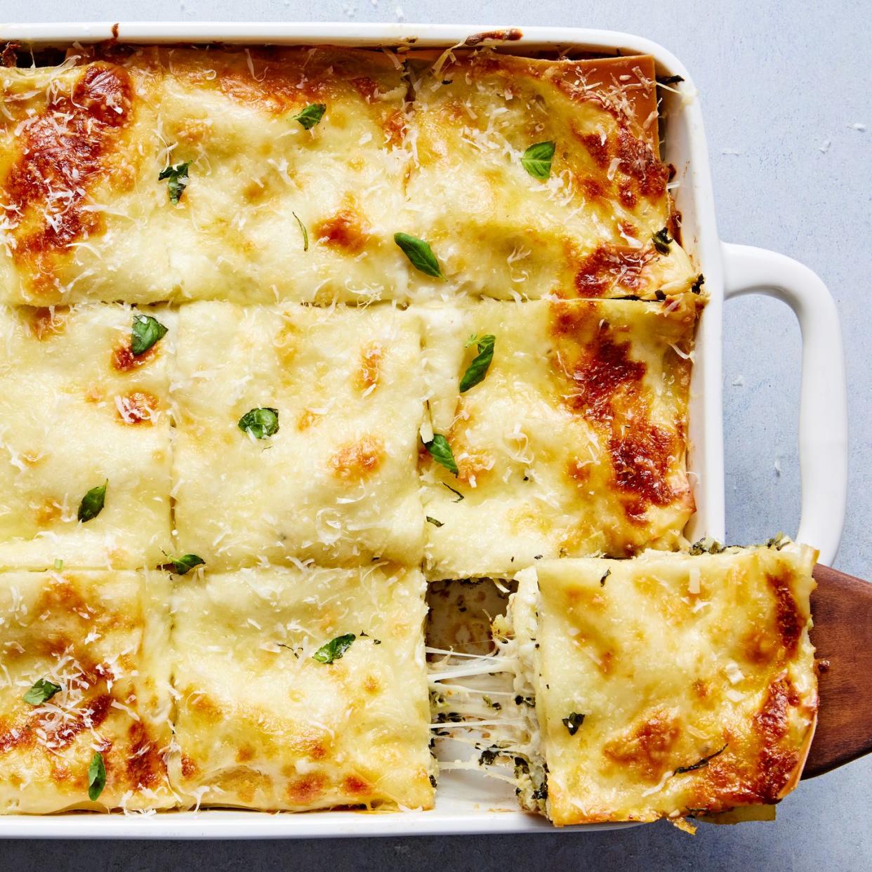 cheesy lasagna with layers of spinach and artichoke
