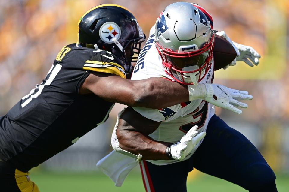 New England Patriots running back Damien Harris is hit by Pittsburgh Steelers linebacker Myles Jack.