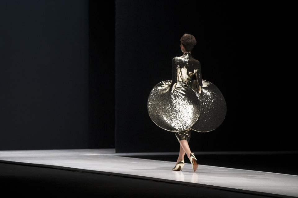 FILE - In this March 22, 2016 file photo, a model displays a creation by French fashion designer Pierre Cardin during Moscow Fashion Week, Russia. Pierre Cardin, the French designer whose famous name embossed myriad consumer products after his iconic Space Age styles shot him into the fashion stratosphere in the 1960s, has died, the French Academy of Fine Arts said Tuesday. He was 98.(AP Photo/Pavel Golovkin, File)