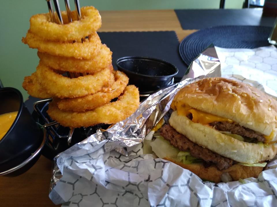 The Big McVegan, a faithful re-creation of a Big Mac, is served with a side of onion rings at the Soulful Vegan in Akron.