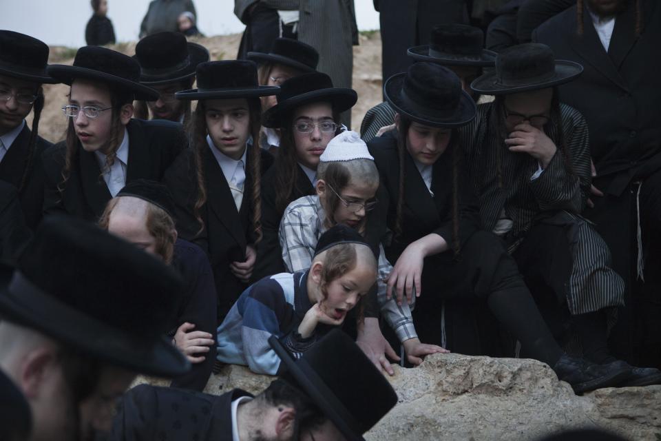 Ultra-Orthodox Jews collect water to make matza during the Maim Shelanoo ceremony at a mountain spring, near Jerusalem, Sunday, April 13, 2014. The water is used to prepare the traditional unleavened bread for the high holiday of Passover which begins Monday.(AP Photo/Dan Balilty)