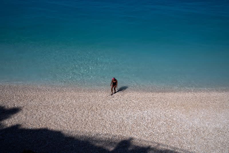 FILE PHOTO: A woman on Porto Katsiki beach on the island of Lefkada, Greece