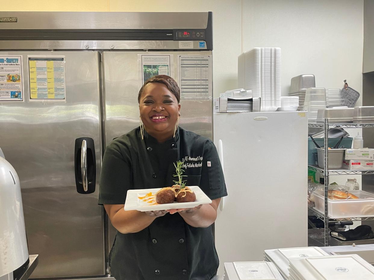 Felsiha Nicholson holding her famous "Crab Beignets" in the Golf Club at Summerbooke kitchen.