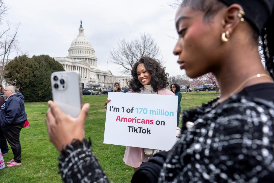 FILE - Devotees of TikTok, Mona Swain, center, and her sister, Rachel Swain, right, both of Atlanta, monitor voting at the Capitol in Washington, as the House passed a bill that would lead to a nationwide ban of the popular video app if its China-based owner doesn't sell, March 13, 2024. If some U.S. lawmakers have their way, the United States and China could end up with something in common: TikTok might not be available in either country. (AP Photo/J. Scott Applewhite, File) ORG XMIT: WX202