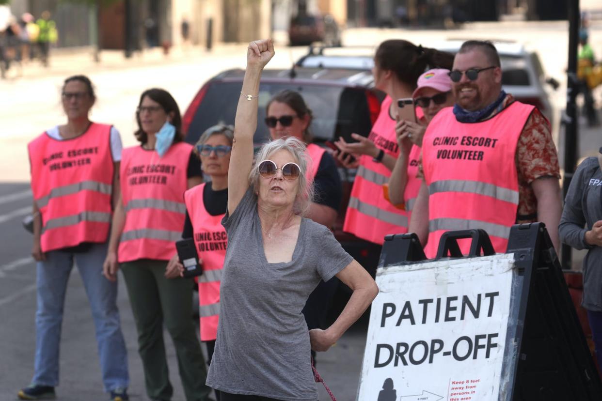 <span class="caption">Workers at a family planning clinic watch an abortion rights march in Chicago on May 14, 2022. </span> <span class="attribution"><a class="link " href="https://media.gettyimages.com/photos/workers-at-a-family-planning-clinic-watch-as-thousands-of-abortion-picture-id1397239127?s=2048x2048" rel="nofollow noopener" target="_blank" data-ylk="slk:Scott Olson/Getty Images;elm:context_link;itc:0;sec:content-canvas">Scott Olson/Getty Images</a></span>