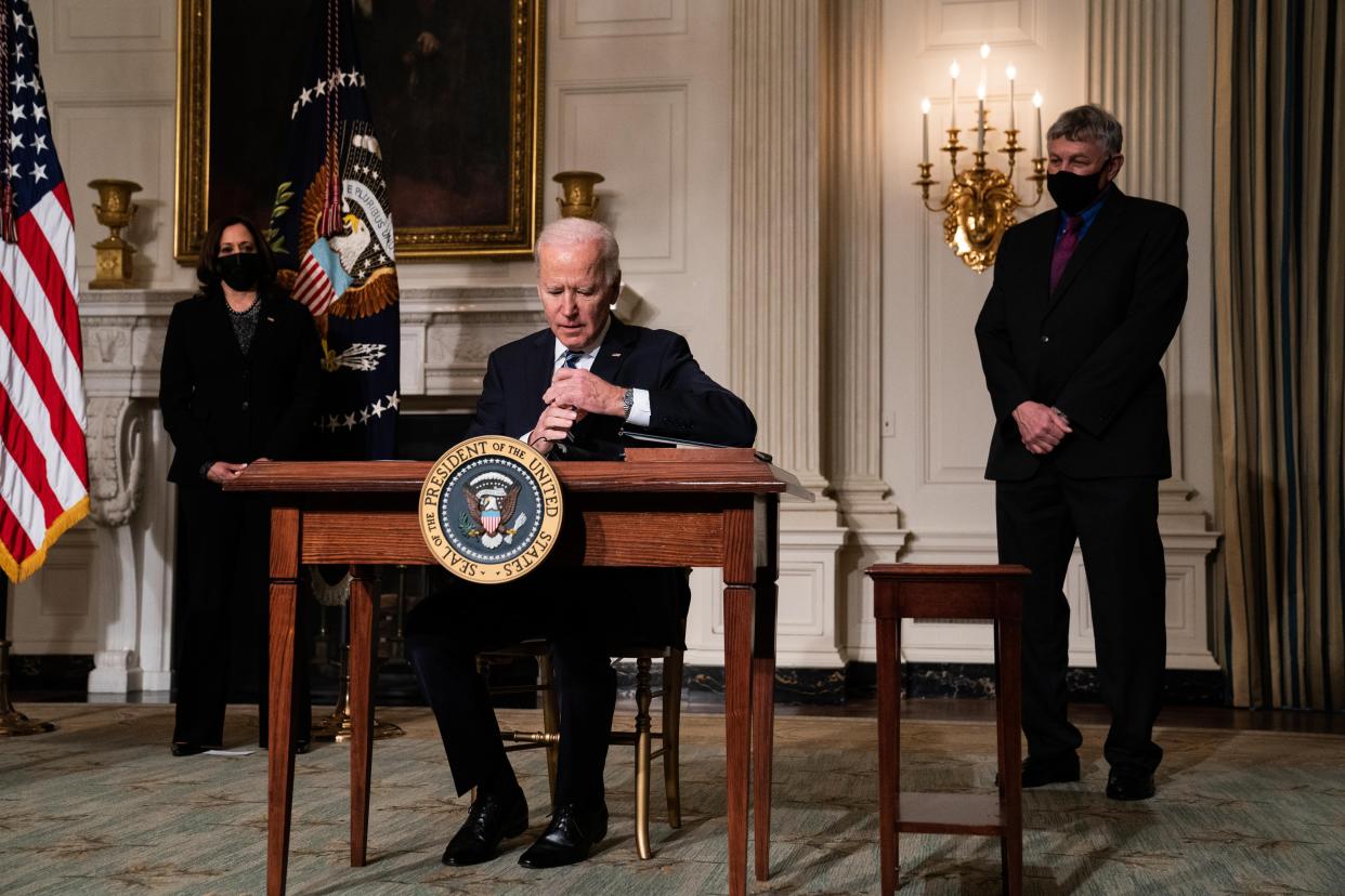 U.S. President Joe Biden signs executive orders after speaking about climate change issues in the State Dining Room of the White House on Jan. 27, 2021, in Washington, DC.