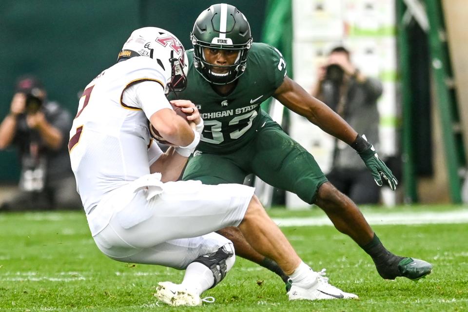 Michigan State's Kendell Brooks, right, closes in on Minnesota's Tanner Morgan during the first quarter on Saturday, Sept. 24, 2022, at Spartan Stadium in East Lansing.